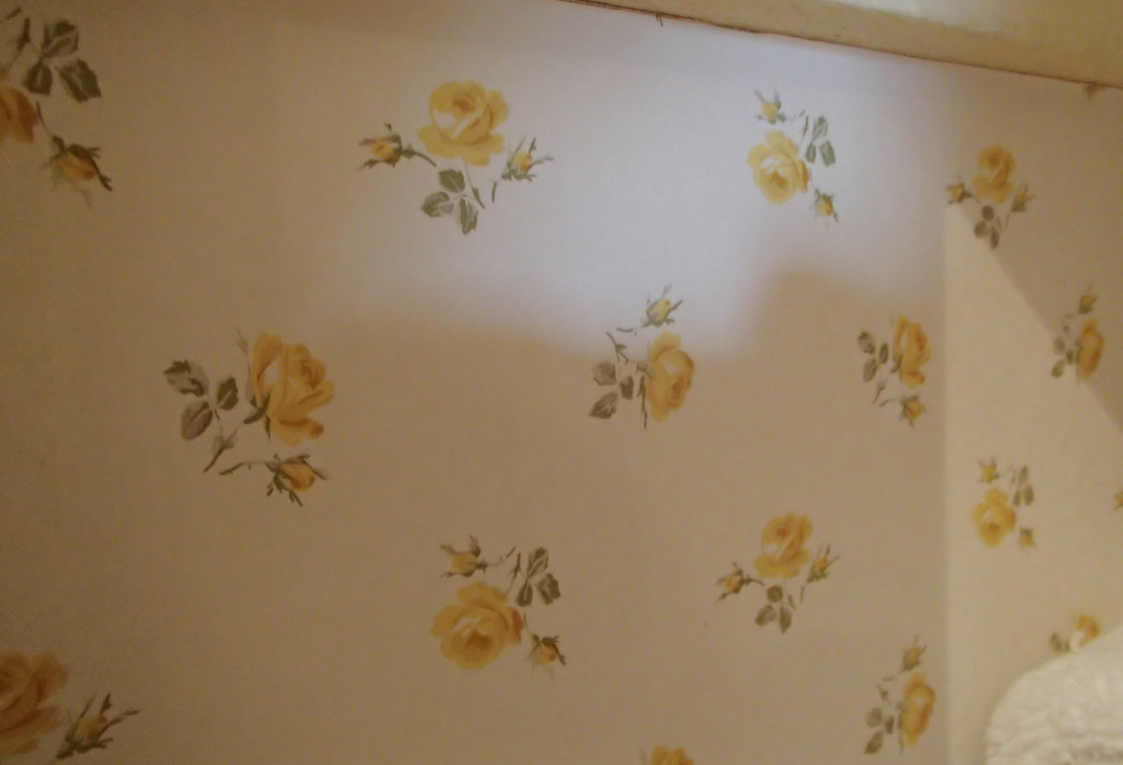 small linen closet - dated wallpaper