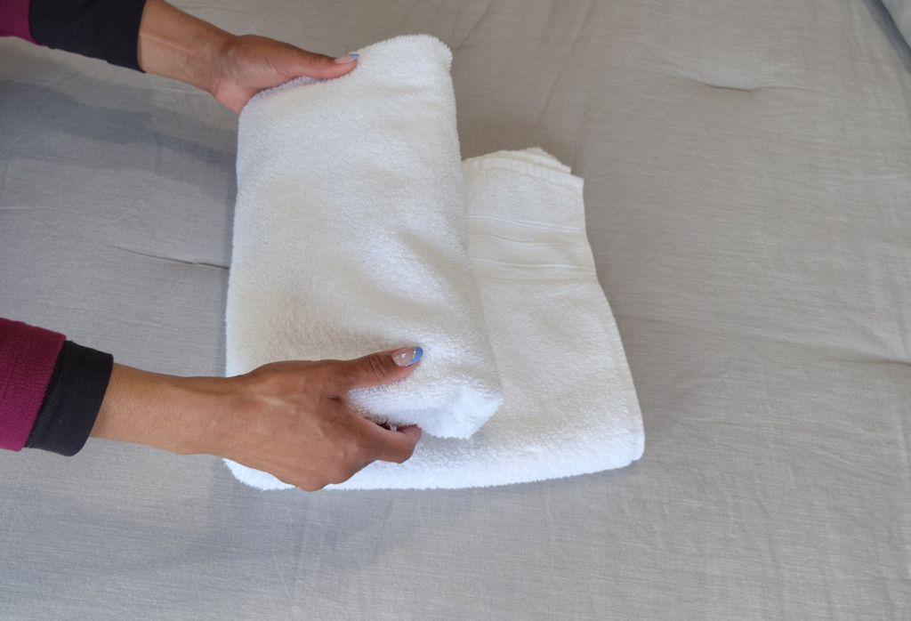 folded towels in linen closet home organization